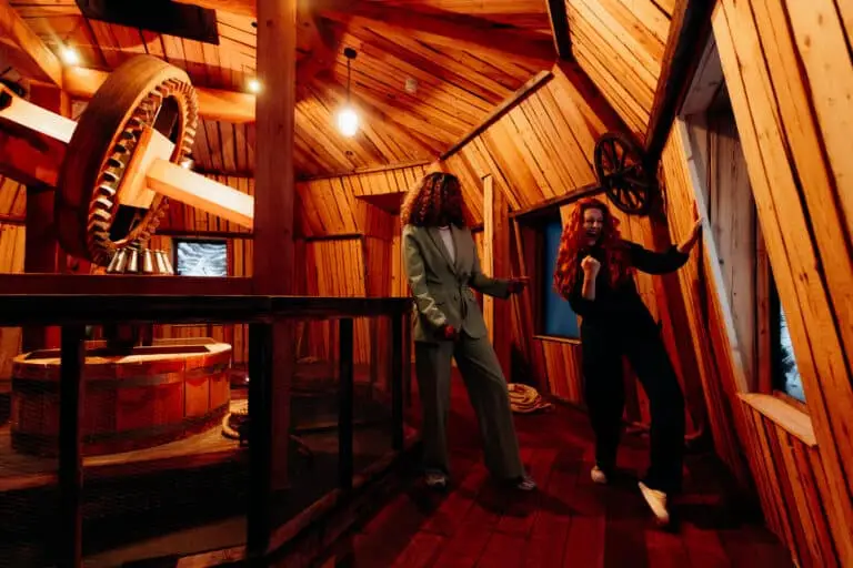 Visitors exploring a traditional Dutch windmill at one of the most unique Amsterdam attractions